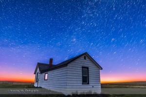 Circumpolar star trails at dawn over the historic Butala homestead at the Old Man on His Back Prairie and Heritage Conservation Area in southwest Saskatchewan, taken May 2015. This is a stack of 70 frames from a larger time-lapse sequence, from the end of the sequence in the dawn twilight. Each exposure is 40 seconds with the 14mm lens at f/2.8 and Canon 60Da at ISO 1600. Stacked with Advanced Stacker Actions. The foreground comes from a stack of 8 of the final exposures, mean combined, to smooth noise.