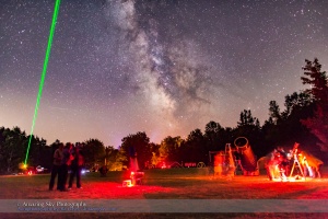 A scene at the Nova East Star Party near Windsor, Nova Scotia, in August 2015, showing laser pointer in use under a clear starry sky.