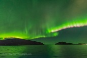The Northern Lights exhibiting the classic pink colour on the lower edge of the curtains from glowing nitrogen molecules, in addition to the main green tint from oxygen. Taken from the Hurigruten ship the m/s Nordlys north of Tromsø on October 24, 2017. This is a single 1-second exposure with the Sigma 14mm Art lens at f/1.8 and Nikon D750 at ISO 6400. Taken as part of a time-lapse sequence.