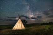 Mars (at left) and the Milky Way (at right) over a single tipi (with another under construction at back) at the Two Trees site at Grasslands National Park, Saskatchewan, August 6, 2018. I placed a low-level warm LED light inside the tipi for the illumination. This is a stack of 6 exposures, mean combined to smooth noise, for the ground, and one untracked exposure for the sky, all 30 seconds at f/2.2 with the 20mm Sigma lens and Nikon D750 at ISO 3200.