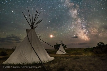 Mars and the Milky Way over the tipis at Two Trees area in Grasslands National Park, Saskatchewan on August 6, 2018. Some light cloud added the haze and glows to the planets and stars. Illumination is by starlight. No light painting was employed here. This is a stack of 8 exposures for the ground, mean combined to smooth noise, and a single untracked exposure for the sky, all 30 seconds at f/2.8 with the Sigma 20mm lens, and Nikon D750 at ISO 6400 with LENR on.