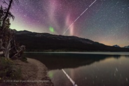 This is a rare appearance of the unusual STEVE auroral arc on the night of July 16-17, 2018, with a relatively low Kp Index of only 2 to 3. While the auroral arc was visible the ISS made a bright pass heading east. This is a blend of a single 15-second exposure for the sky and ground, with seven 15-second exposures for the ISS, but masked to reveal just the ISS trail and its reflection in the water. The ISS shots were taken at 3-second intervals, thus the gaps. All with the Sigma 20mm Art lens at f/2 and Nikon D750 at ISO 6400. Taken from Bow Lake, Banff National Park, Alberta.